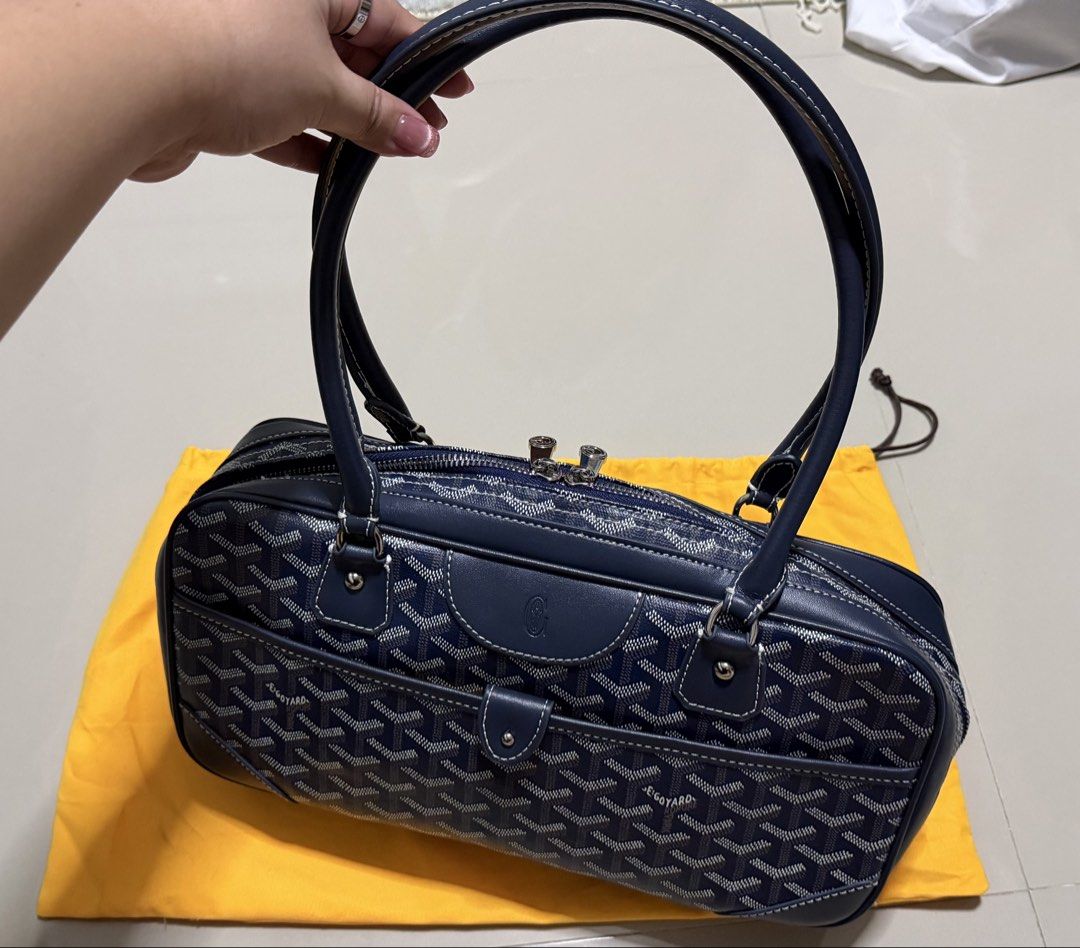 Goyard Navy St. Martin Bag (Category: Luxury Bags & Wallets) located in Pasig City. Submitted by dancieaa03 (Listing ID 1451876447, Image 3). Description: - Classic Goyard Boston bag in navy blue - Features the iconic Goyard monogram pattern - Genuine leather handles and trim - Secure zipper closure - Comes with Goyard dust bag - Stylish and practical for everyday use - Ample interior space This bag is NGA.