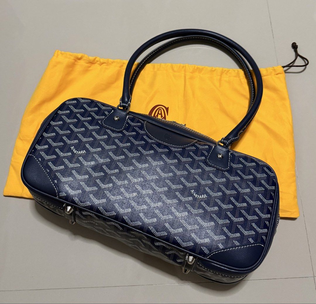 Goyard Navy St. Martin Bag (Category: Luxury Bags & Wallets) located in Pasig City. Submitted by dancieaa03 (Listing ID 1451876447, Image 2). Description: - Classic Goyard Boston bag in navy blue - Features the iconic Goyard monogram pattern - Genuine leather handles and trim - Secure zipper closure - Comes with Goyard dust bag - Stylish and practical for everyday use - Ample interior space This bag is NGA.