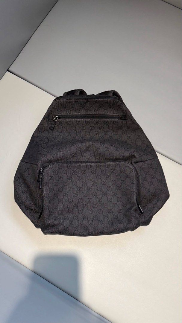 Gucci GG Monogram Canvas Backpack (Category: Luxury Bags & Wallets) located in Rizal. Submitted by ms.shade (Listing ID 1451775037, Image 2). Description: - Authentic Gucci backpack - Classic GG monogram pattern - Durable canvas with leather trim - Front zip pocket - Main compartment - Drawstring closure with buckle flap - Includes original dust bag - Ideal for everyday use or travel.