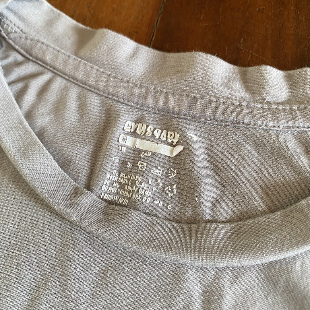 Gymshark t-shirt (Category: Tshirts & Polo Shirts ) located in Naga. Submitted by decluttertingz_ (Listing ID 1451746240, Image 3). Description: Gymshark t shirt M but fits S 20x26” Condition 9.5/10 Very soft and comfy fabric for working out! Issue: Peeling neck tag .