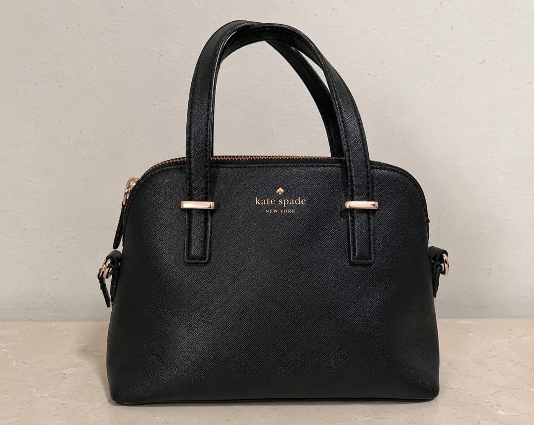 Kate Spade Dome Saffiano Leather Sling Bag (Category: Luxury Bags & Wallets) located in Batangas. Submitted by curatedluxxe88 (Listing ID 1451822737, Image 1). Description: - Classic black Kate Spade dome satchel - Textured leather with rose gold hardware - Top handles and zip closure - Spacious interior for essentials - Versatile for daily use or special occasions - Clean and simple design.