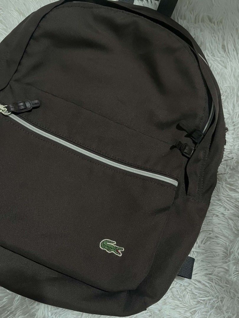 Lacoste Brown Polyester Backpack (Category: Backpacks) located in Manila. Submitted by senggggg. (Listing ID 1451835320, Image 2). Description: good condition working zip check details issue and size.