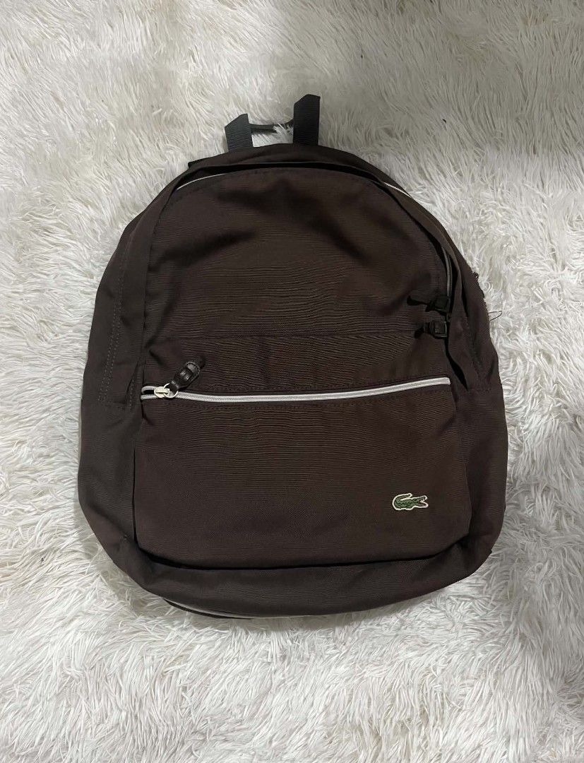 Lacoste Brown Polyester Backpack (Category: Backpacks) located in Manila. Submitted by senggggg. (Listing ID 1451835320, Image 1). Description: good condition working zip check details issue and size.