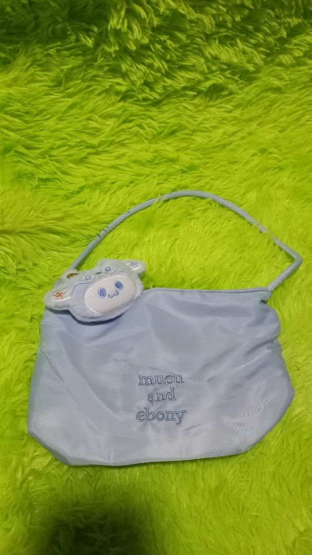 Light Blue Armpit Single Shoulder Bucket Bag Tote Bag (Category: Tote Bags) located in Manila. Submitted by twinklelyn03 (Listing ID 1451772570, Image 2). Description: - Adorable light blue bucket bag - Secure snap button closure - Comes with a cute fluffy bunny charm - 'mucu and ebony' embroidered logo on the front - Ideal for everyday use - Fits all your daily essentials see photos for details pm sa sure buyer only thank you so much po!.