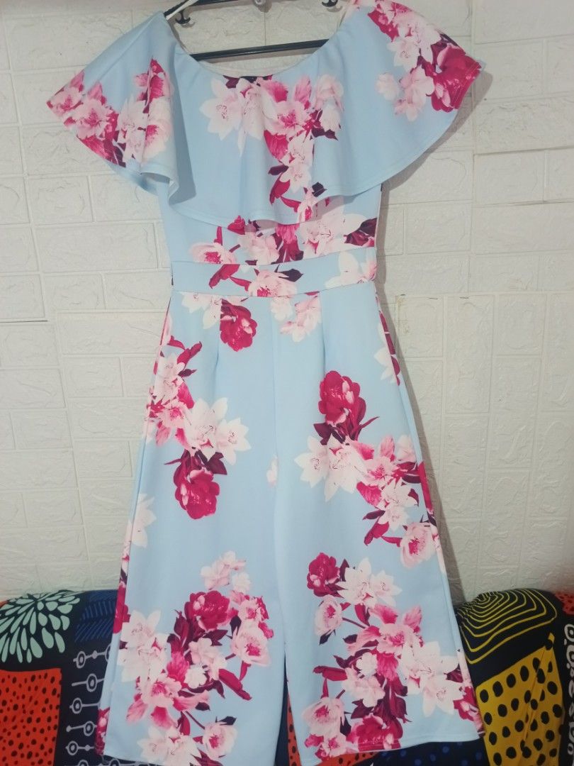 Light Blue Floral Off-Shoulder Ruffle Jumpsuit (Category: Jumpsuits) located in Digos. Submitted by chicandglowbargains (Listing ID 1451735696, Image 2). Description: - Cute light blue jumpsuit with vibrant floral print - Off-the-shoulder neckline with ruffle detail - Wide leg culotte style - Versatile for casual outings or parties - Comfortable and stylish.