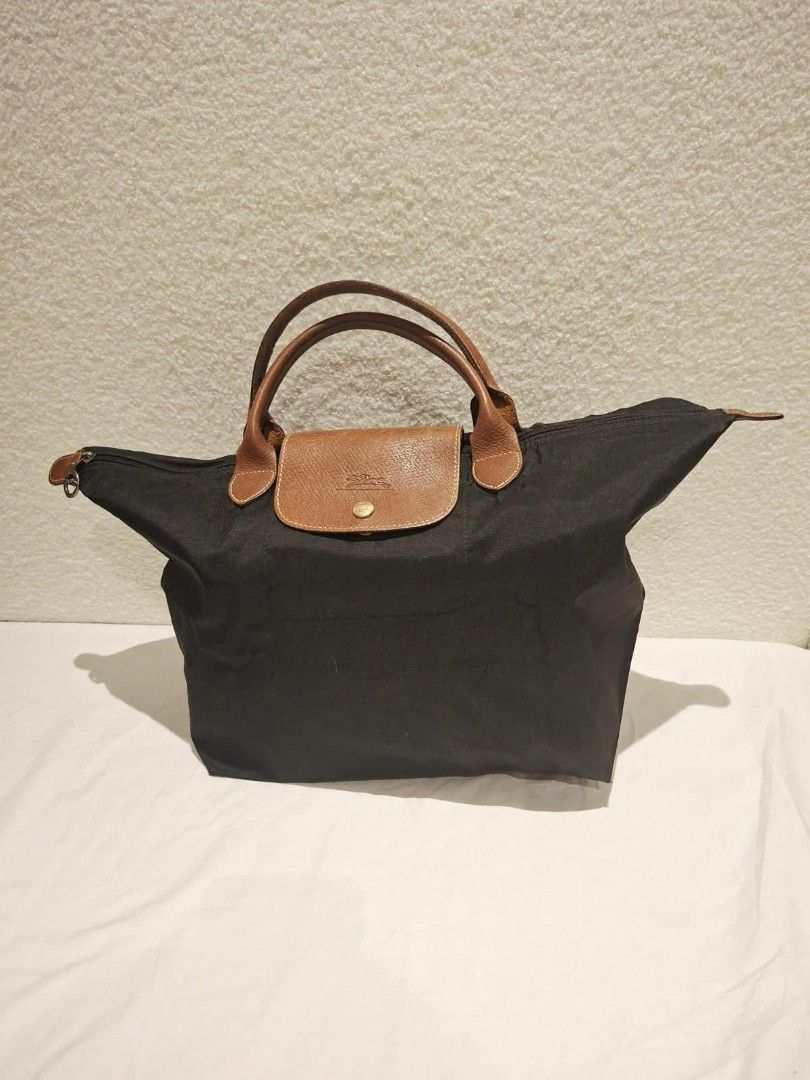 Longchamp Le Pliage Cuir Small Top Handle Bag Black (Category: Luxury Bags & Wallets) located in Makati City. Submitted by jacky222323 (Listing ID 1451824157, Image 1). Description: - Classic Longchamp bag in black - Small/Medium size, ideal for daily essentials - Made with durable nylon and leather trim - Features top zip closure with a snap-button flap - Comfortable leather handles - Folds flat for convenient storage - Versatile for any occasio