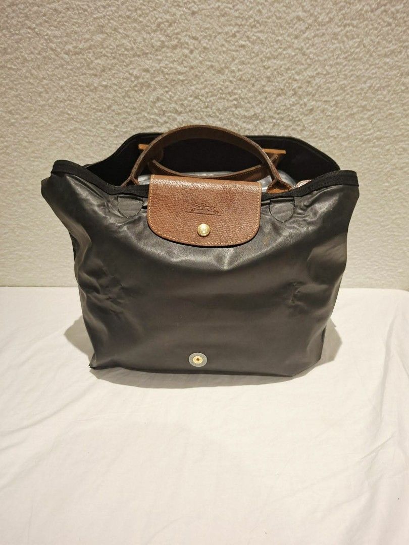 Longchamp Le Pliage Cuir Small Top Handle Bag Black (Category: Luxury Bags & Wallets) located in Makati City. Submitted by jacky222323 (Listing ID 1451824157, Image 3). Description: - Classic Longchamp bag in black - Small/Medium size, ideal for daily essentials - Made with durable nylon and leather trim - Features top zip closure with a snap-button flap - Comfortable leather handles - Folds flat for convenient storage - Versatile for any occasio