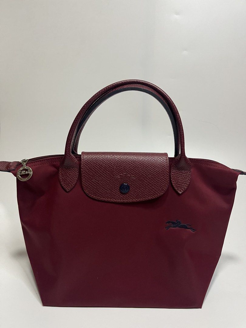 Longchamp Le Pliage Tote Bag Burgundy (Category: Luxury Bags & Wallets) located in Manila. Submitted by niandv (Listing ID 1451850846, Image 1). Description: - Authentic Longchamp Le Pliage tote bag - Color: Burgundy - Material: Nylon body with leather handles and trim - Iconic horse logo embroidery - Interior: Main compartment and small pocket - Origin: Made in France - Ideal for everyday essentials.