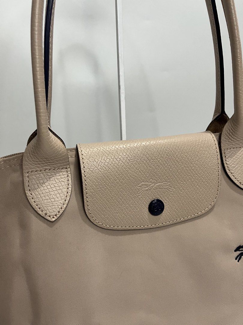 Longchamp Le Pliage Tote Bag Beige (Category: Luxury Bags & Wallets) located in Manila. Submitted by niandv (Listing ID 1451852266, Image 3). Description: - Classic Longchamp tote bag - Color: Beige nylon with tan leather trim and handles - Iconic horse logo detail - Secure closure: Zipper with snap-button flap - Spacious interior, ideal for everyday use - Versatile and can fit a lot.
