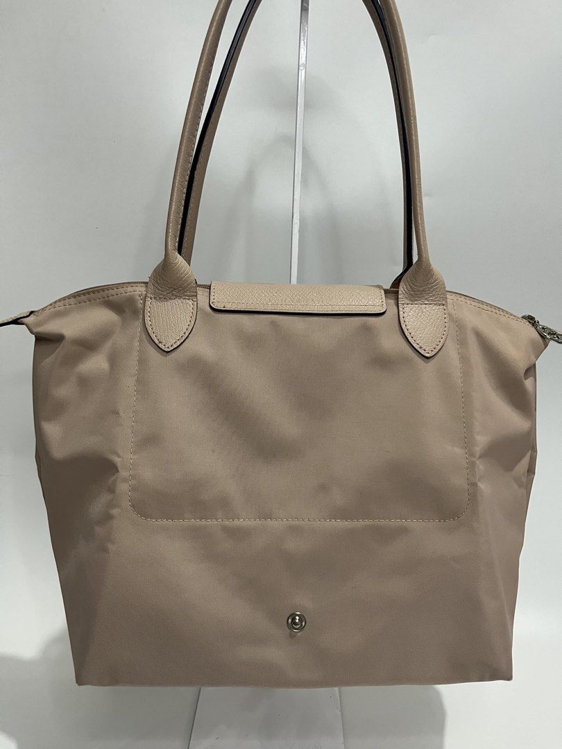 Longchamp Le Pliage Tote Bag Beige (Category: Luxury Bags & Wallets) located in Manila. Submitted by niandv (Listing ID 1451852266, Image 2). Description: - Classic Longchamp tote bag - Color: Beige nylon with tan leather trim and handles - Iconic horse logo detail - Secure closure: Zipper with snap-button flap - Spacious interior, ideal for everyday use - Versatile and can fit a lot.