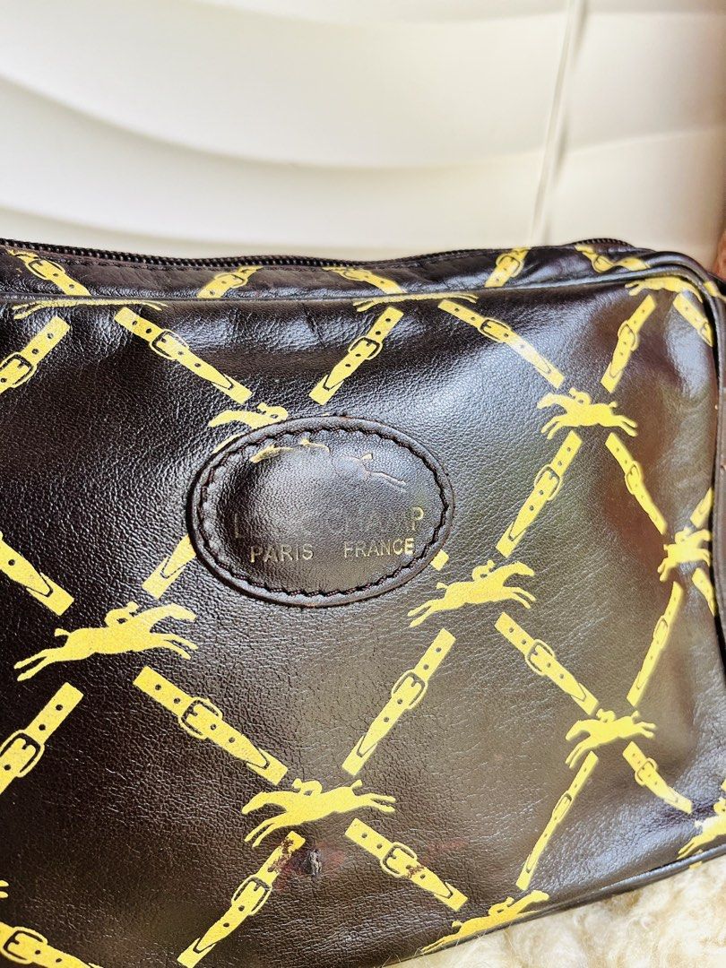 Longchamp Paris Crossbody Bag (Category: Cross-body Bags) located in Davao. Submitted by goodthingsph_ (Listing ID 1451734419, Image 3). Description: - Classic black with gold horse and buckle print - Genuine leather strap and trim - Secure zipper closure - Interior shows some signs of wear - Ideal for everyday use - Timeless piece from Longchamp Paris.