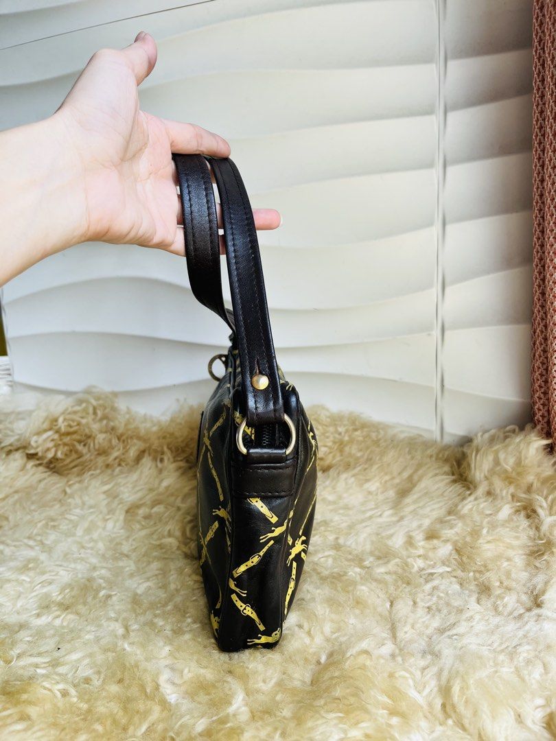 Longchamp Paris Crossbody Bag (Category: Cross-body Bags) located in Davao. Submitted by goodthingsph_ (Listing ID 1451734419, Image 2). Description: - Classic black with gold horse and buckle print - Genuine leather strap and trim - Secure zipper closure - Interior shows some signs of wear - Ideal for everyday use - Timeless piece from Longchamp Paris.