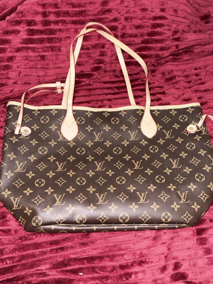 Louis Vuitton Monogram Tote Bag with Pouch (Category: Luxury Bags & Wallets) located in Santa Rosa. Submitted by lynjaneee (Listing ID 1451867873, Image 1). Description: - Classic Louis Vuitton Monogram tote bag - Features a stylish red striped interior - Includes a convenient zippered pocket inside - Comes with a matching monogram pouch - Ideal for everyday use or travel - Spacious and chic design.
