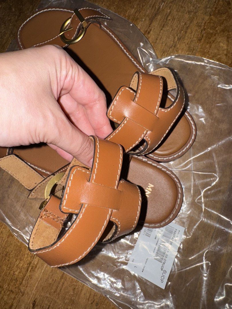 Mango Cognac Bovine Leather Strappy Sandals (Category: Flats & Sandals) located in Paranaque City. Submitted by mykindofclothing (Listing ID 1451723545, Image 3). Description: Mango cognac leather sandals with gold buckle. Flat sole. Original price at 4,295. Uses 100% bovine leather & rubber outsole. Brand new without tags..