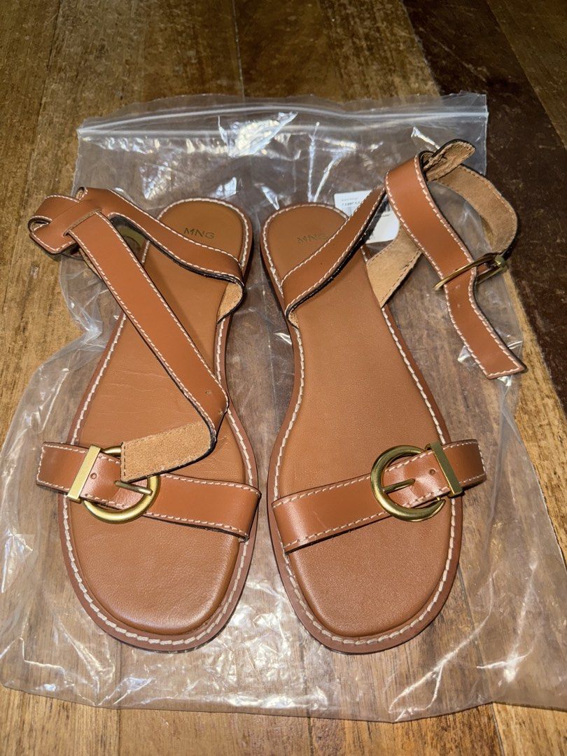 Mango Cognac Bovine Leather Strappy Sandals (Category: Flats & Sandals) located in Paranaque City. Submitted by mykindofclothing (Listing ID 1451723545, Image 2). Description: Mango cognac leather sandals with gold buckle. Flat sole. Original price at 4,295. Uses 100% bovine leather & rubber outsole. Brand new without tags..