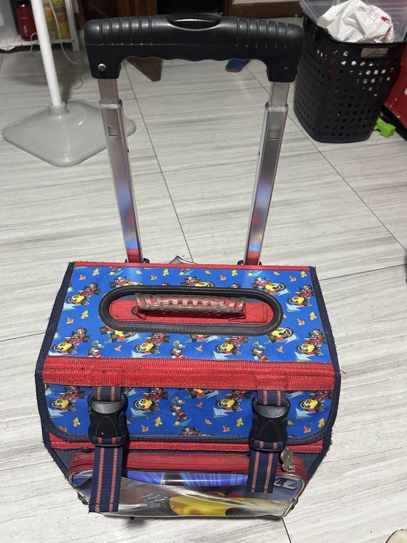 Mickey Mouse Rolling Backpack for Kids (Category: Diaper Bags & Wetbags) located in Paranaque City. Submitted by allthatclutterph (Listing ID 1451825134, Image 1). Description: - Adorable Mickey Mouse rolling backpack for kids. - Features a fun racing design with Mickey. - Easy transport with retractable handle and wheels. - Main compartment includes internal pockets. - Secure front buckle closure. - Perfect for school or travel. - Shows some sig