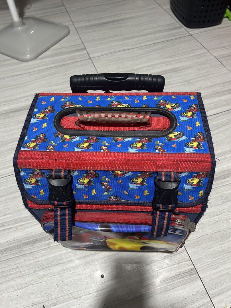 Mickey Mouse Rolling Backpack for Kids (Category: Diaper Bags & Wetbags) located in Paranaque City. Submitted by allthatclutterph (Listing ID 1451825134, Image 3). Description: - Adorable Mickey Mouse rolling backpack for kids. - Features a fun racing design with Mickey. - Easy transport with retractable handle and wheels. - Main compartment includes internal pockets. - Secure front buckle closure. - Perfect for school or travel. - Shows some sig