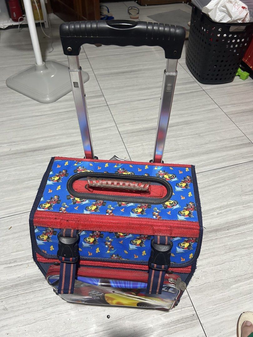 Mickey Mouse Rolling Backpack for Kids (Category: Diaper Bags & Wetbags) located in Paranaque City. Submitted by allthatclutterph (Listing ID 1451825134, Image 2). Description: - Adorable Mickey Mouse rolling backpack for kids. - Features a fun racing design with Mickey. - Easy transport with retractable handle and wheels. - Main compartment includes internal pockets. - Secure front buckle closure. - Perfect for school or travel. - Shows some sig