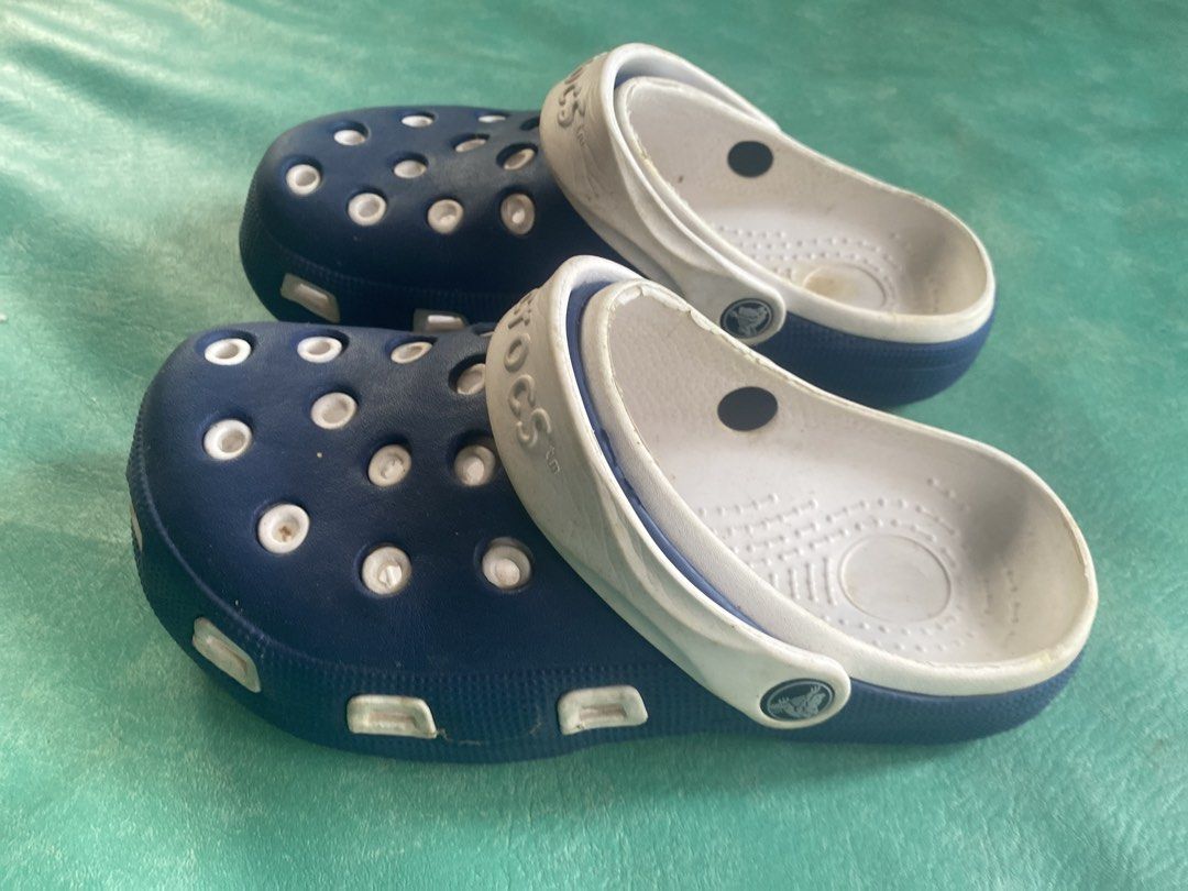 Navy Blue Crocs with White Trim (Category: Slippers and slides) located in Manila. Submitted by narsonlineexpression (Listing ID 1451782478, Image 2). Description: - Classic navy blue Crocs - White trim detail - Easy slip-on and off design - Perfect for casual wear or gardening - Minor scuffs visible on white trim - Soles are in good, usable condition - Ready for a new owner!.