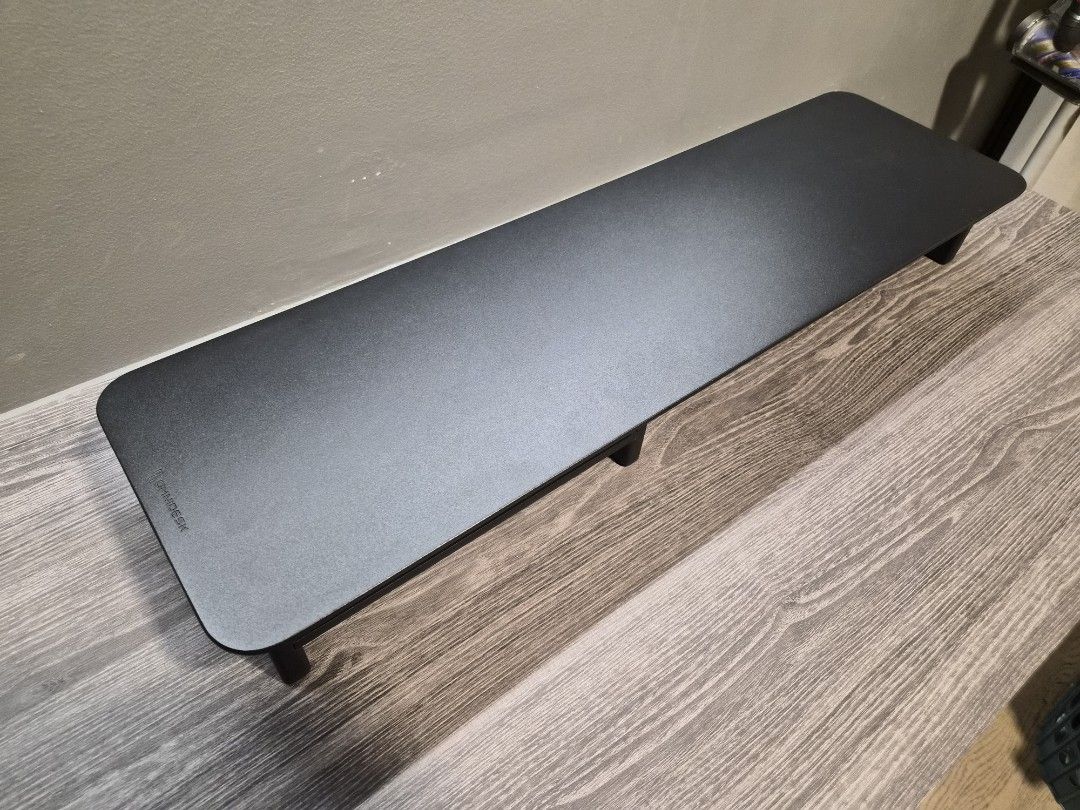 Omnidesk Desk Riser (Category: Tables & Sets) located in Singapore. Submitted by bongaaaaa (Listing ID 1451833421, Image 2). Description: Omnidesk desk riser in black wood, like new condition. Hardly used at all. Dimensions: 80x23x10.5cm RRP $89 .