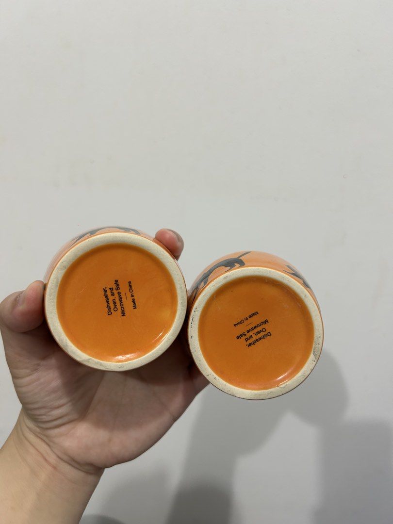 Orange Black Cat Ceramic Cups Set of 2 (Category: Coffee & Tea Tableware) located in Makati City. Submitted by michellecollado07 (Listing ID 1451892282, Image 3). Description: - Set of 2 cute orange cups with black cat design - Perfect for Halloween or cat lovers - Dishwasher, oven, and microwave safe - Ideal for coffee, tea, or small snacks - Made in China.