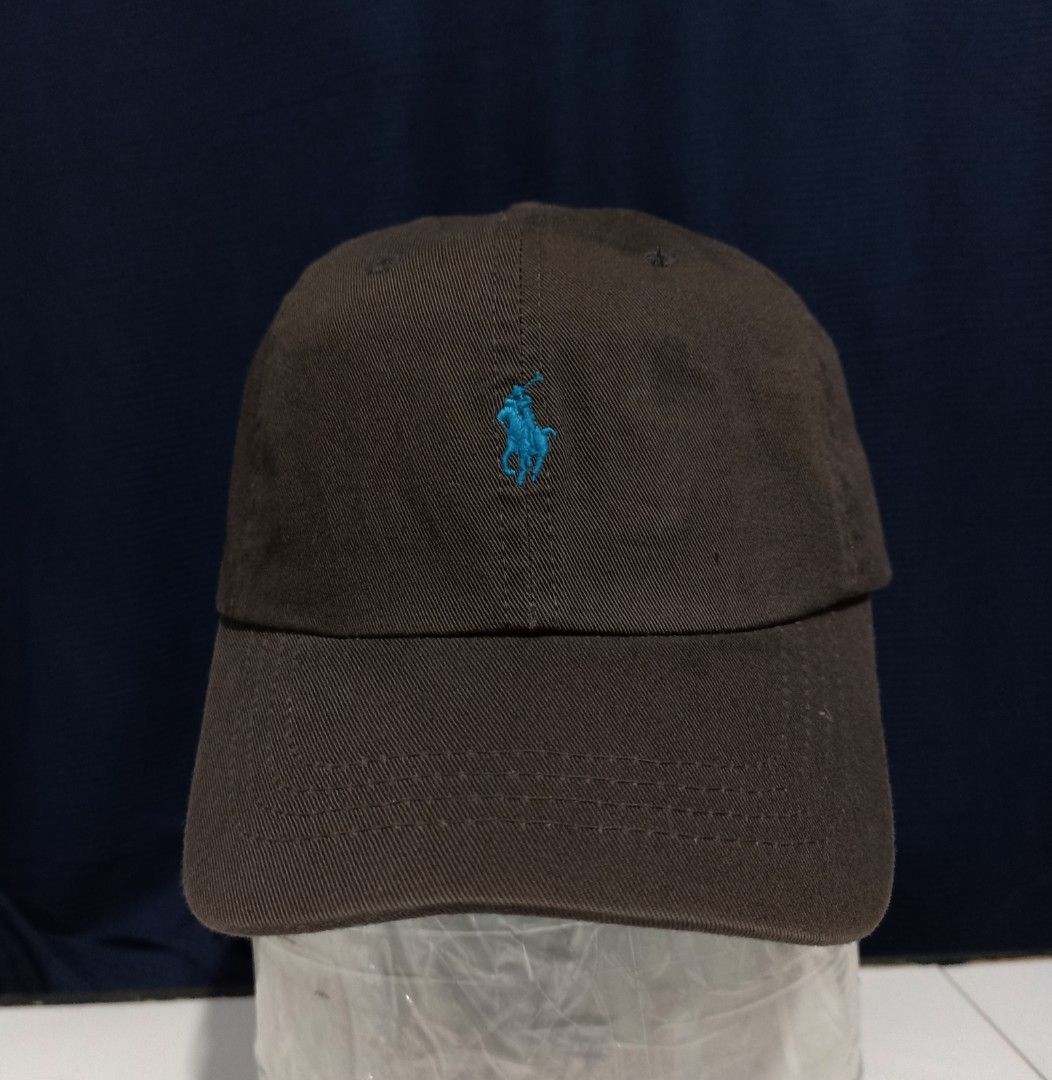 Polo Ralph Lauren Cap - Brown with Blue Logo (Category: Caps & Hats) located in Marawi City. Submitted by abdullah0692139 (Listing ID 1451860096, Image 1). Description: - Authentic Polo Ralph Lauren brown baseball cap - Features the iconic blue polo player logo on the front - 'POLO' embroidered in blue on the back - Adjustable strap with leather detail - Ideal for everyday wear.