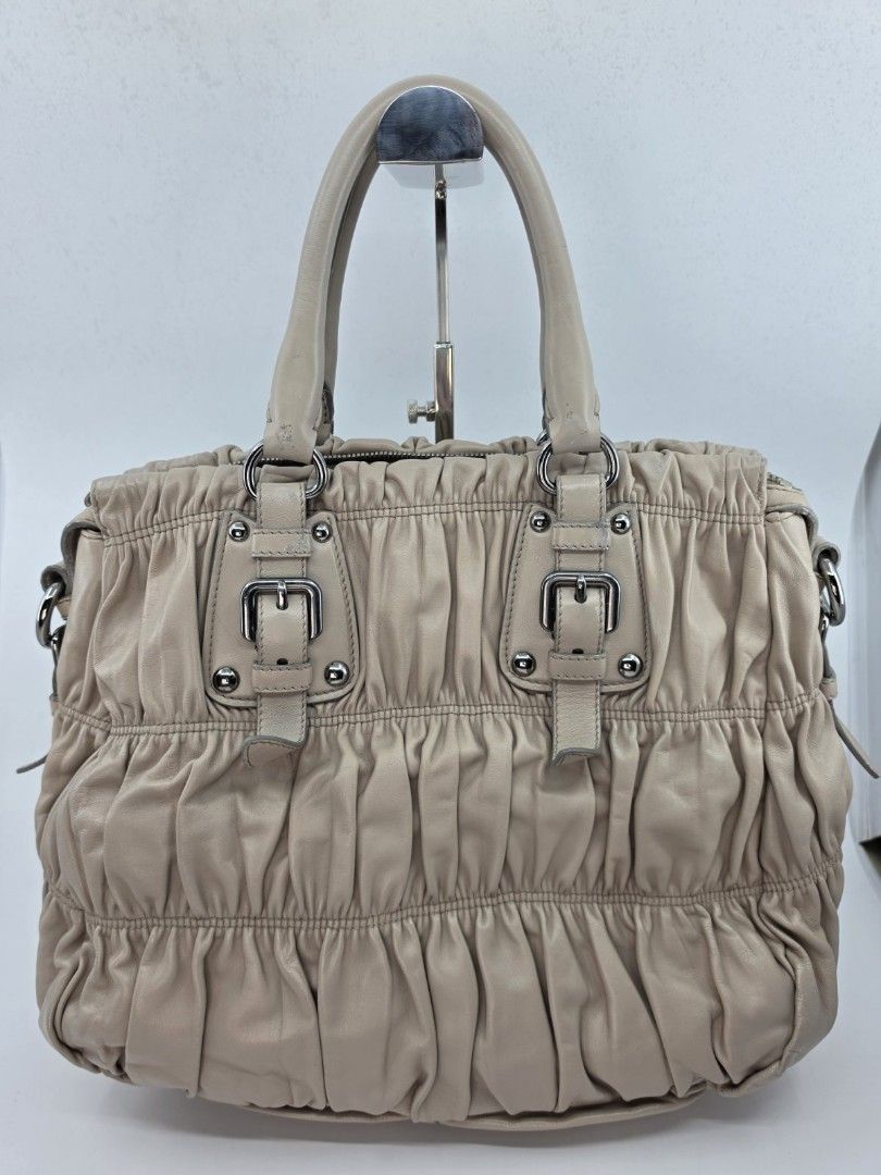 PRADA NAPPA GAUFRE RUCHED BAG (Category: Luxury Bags & Wallets) located in Quezon City. Submitted by nadine_miel (Listing ID 1451857039, Image 2). Description: ⚜️ ruched lambskin leather ⚜️ light beige-taupe color ⚜️ silver tone hardware ⚜️ medium size ⚜️ Onhand, ready to ship.