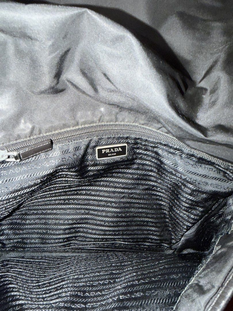 Prada Nylon Messenger Bag (Category: Luxury Bags & Wallets) located in Cainta. Submitted by emcyo (Listing ID 1451721278, Image 3). Description: - Authentic Prada messenger bag - Durable nylon material with elegant leather trim - Secure buckle closure on the front flap - Interior zippered pocket for essentials - Shows some signs of wear on exterior fabric, adding character - Ideal for everyday carry and versatile use - lost hardlock “Kindly lower