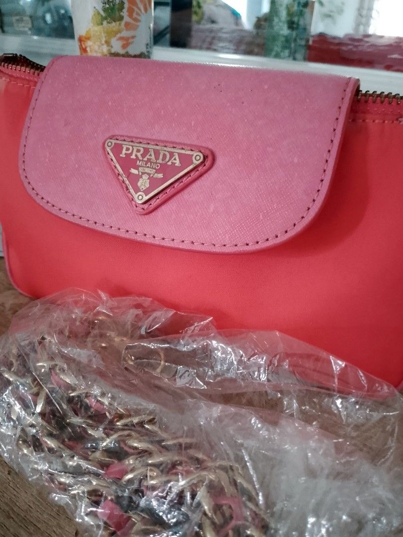 Prada Pink Nylon Chain Shoulder Bag (Category: Luxury Bags & Wallets) located in Carmen. Submitted by badkiss_coffee26 (Listing ID 1451852916, Image 3). Description: - Authentic Prada bag in a lovely pink shade. - Durable nylon material with a chic leather flap. - Elegant gold chain strap accented with pink leather. - Comes with original authenticity card. - Versatile for casual day trips or sophisticated evenings. - Secure zipper closure. - Inte