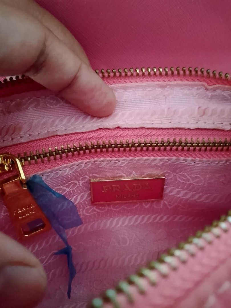 Prada Pink Nylon Chain Shoulder Bag (Category: Luxury Bags & Wallets) located in Carmen. Submitted by badkiss_coffee26 (Listing ID 1451852916, Image 2). Description: - Authentic Prada bag in a lovely pink shade. - Durable nylon material with a chic leather flap. - Elegant gold chain strap accented with pink leather. - Comes with original authenticity card. - Versatile for casual day trips or sophisticated evenings. - Secure zipper closure. - Inte