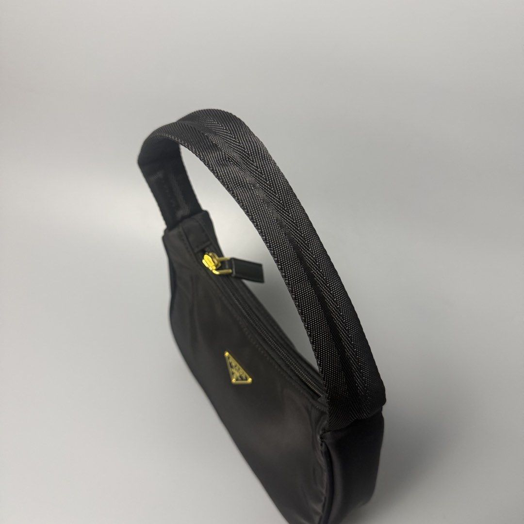 Prada re-edition (Category: Luxury Bags & Wallets) located in Malasiqui. Submitted by fosh0fosh0 (Listing ID 1451760371, Image 3). Description: - Stylish black bag - Durable nylon-like material - Shiny gold zipper pull with logo - Black beaded zipper detail - Ideal for everyday use.
