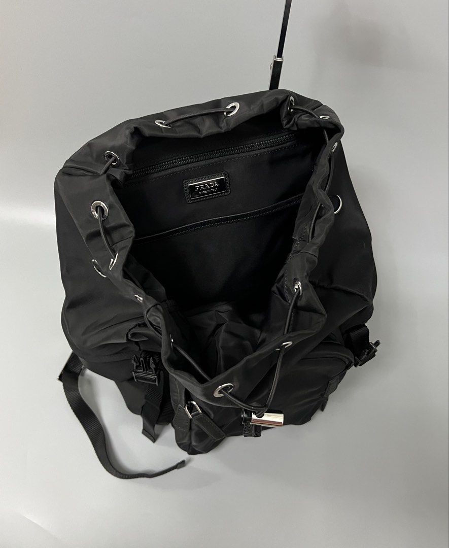Prada Re-Nylon and Saffiano Leather Backpack (Category: Luxury Bags & Wallets) located in Bacoor. Submitted by southlocalgarage (Listing ID 1451586934, Image 3). Description: Prada Re-Nylon and Saffiano Leather Backpack’ Rank A Lampo underzip Width white tag No.255 As new condition No issue Details! Leather handle Adjustable woven nylon straps Enameled metal triangle logo on flap Push-lock clasp on the flap Four external zipper pockets Padded mes