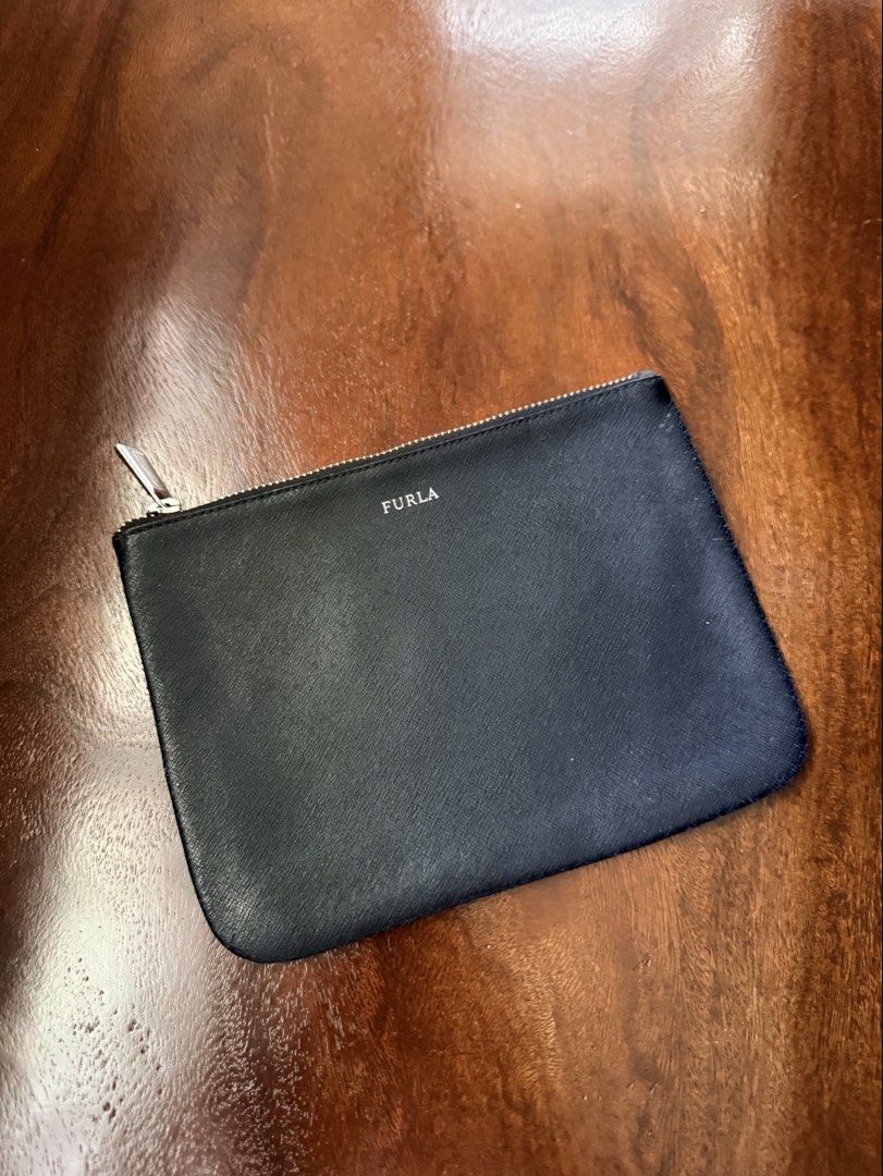 Preloved Furla pouch/clutch bag (Category: Purses & Pouches) located in Naga. Submitted by pritilen (Listing ID 1451709506, Image 1). Description: This is a Furla Saffiano leather black clutch bag featuring a minimalist silver-toned logo. Preloved Authentic Furla roomy, can fit pro max phones .