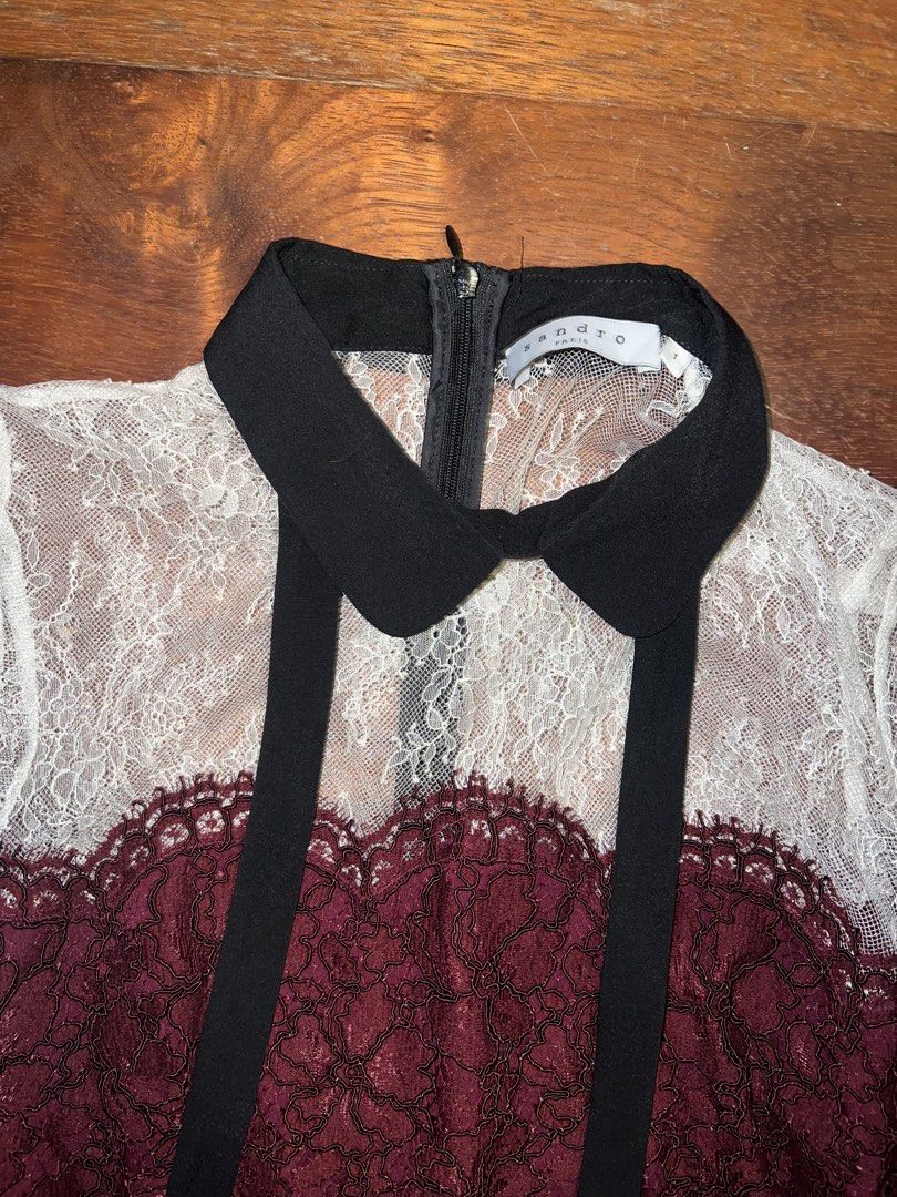 Sandro Lace Dress (Category: Dresses) located in Tuguegarao City. Submitted by pauloveditems (Listing ID 1451745959, Image 1). Description: - Elegant burgundy, black, and white lace dress - Short sleeves with a charming Peter Pan collar - Adorable tie detail at the neck - Flattering knee-length silhouette - Estimated size: 2.