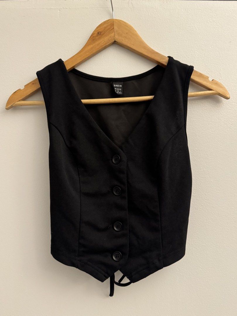 SHEIN Black Terno Button-Up Vest with Tie Back W/ black slacks (Category: Sets or Coordinates) located in Manila. Submitted by closetclearout.mnl (Listing ID 1451890106, Image 1). Description: - Comes with black pants (waist: 23-25in) (length: 140cm) - SHEIN black vest - Button-up front with 4 buttons - Adjustable tie detail at the back for a custom fit - Cropped style, great for layering over tops or dresses.