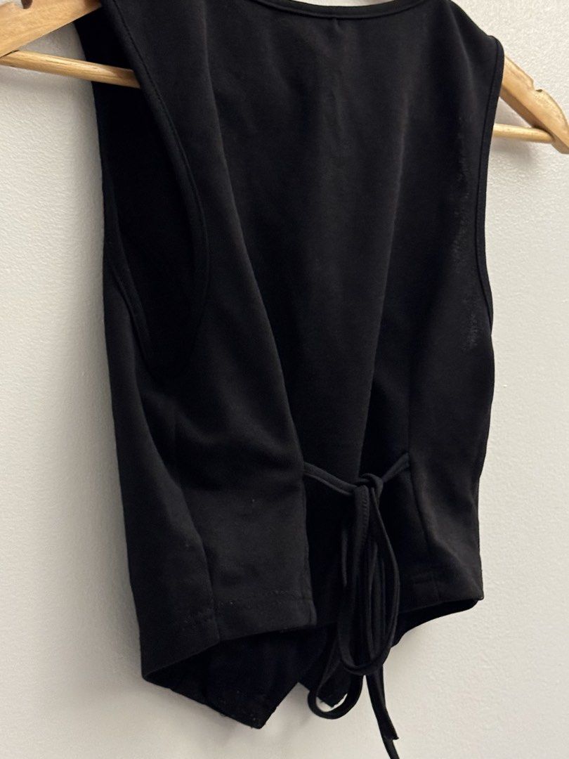 SHEIN Black Terno Button-Up Vest with Tie Back W/ black slacks (Category: Sets or Coordinates) located in Manila. Submitted by closetclearout.mnl (Listing ID 1451890106, Image 2). Description: - Comes with black pants (waist: 23-25in) (length: 140cm) - SHEIN black vest - Button-up front with 4 buttons - Adjustable tie detail at the back for a custom fit - Cropped style, great for layering over tops or dresses.