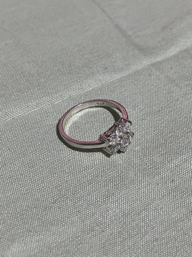 Silver Flower Ring with Clear Stones S925 (Category: Rings) located in Tagudin. Submitted by aljaneaddtoukart (Listing ID 1451799673, Image 2). Description: - Adorable flower-shaped ring - Features clear stones - Set in a silver-toned metal - Simple, classic band - Estimated size: 6 or 7 - Ideal for everyday wear - Makes a lovely gift - Adds a touch of sparkle.