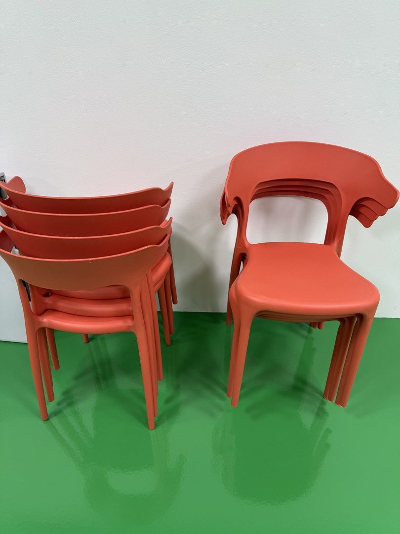 Stackable Orange Plastic Chairs (Category: Chairs) located in Singapore. Submitted by cocoberry99 (Listing ID 1451748565, Image 1). Description: - Set of 5 orange plastic chairs - Stackable design for convenient storage - Durable plastic construction - Vibrant orange color - Ideal for events, cafes, or extra home seating.