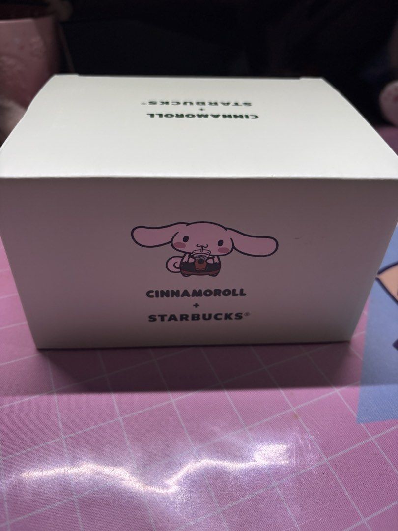 Starbucks Cinnamoroll Collaboration Mug (Category: Coffee & Tea Tableware) located in San Juan City. Submitted by claricecaswell22 (Listing ID 1451820169, Image 2). Description: - Adorable Cinnamoroll Starbucks collaboration mug. - Comes with its original box. - Features Cinnamoroll's face on the front. - Collaboration logo on the back. - Dark green handle detail. - Ideal for coffee or tea lovers. - Perfect gift for Cinnamoroll and Starbucks fans