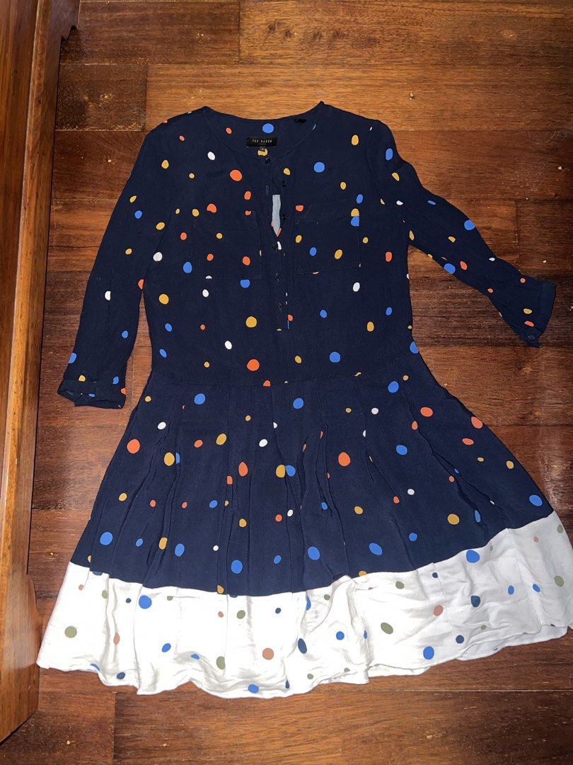 Ted Baker Navy Polka Dot Dress Size 1 (Category: Dresses) located in Tuguegarao City. Submitted by pauloveditems (Listing ID 1451745787, Image 2). Description: - Navy blue dress with colorful polka dots - Long sleeves - Button-up front - Elasticated waist - Tiered skirt - White hem with polka dots - Versatile for casual outings or dressing up.