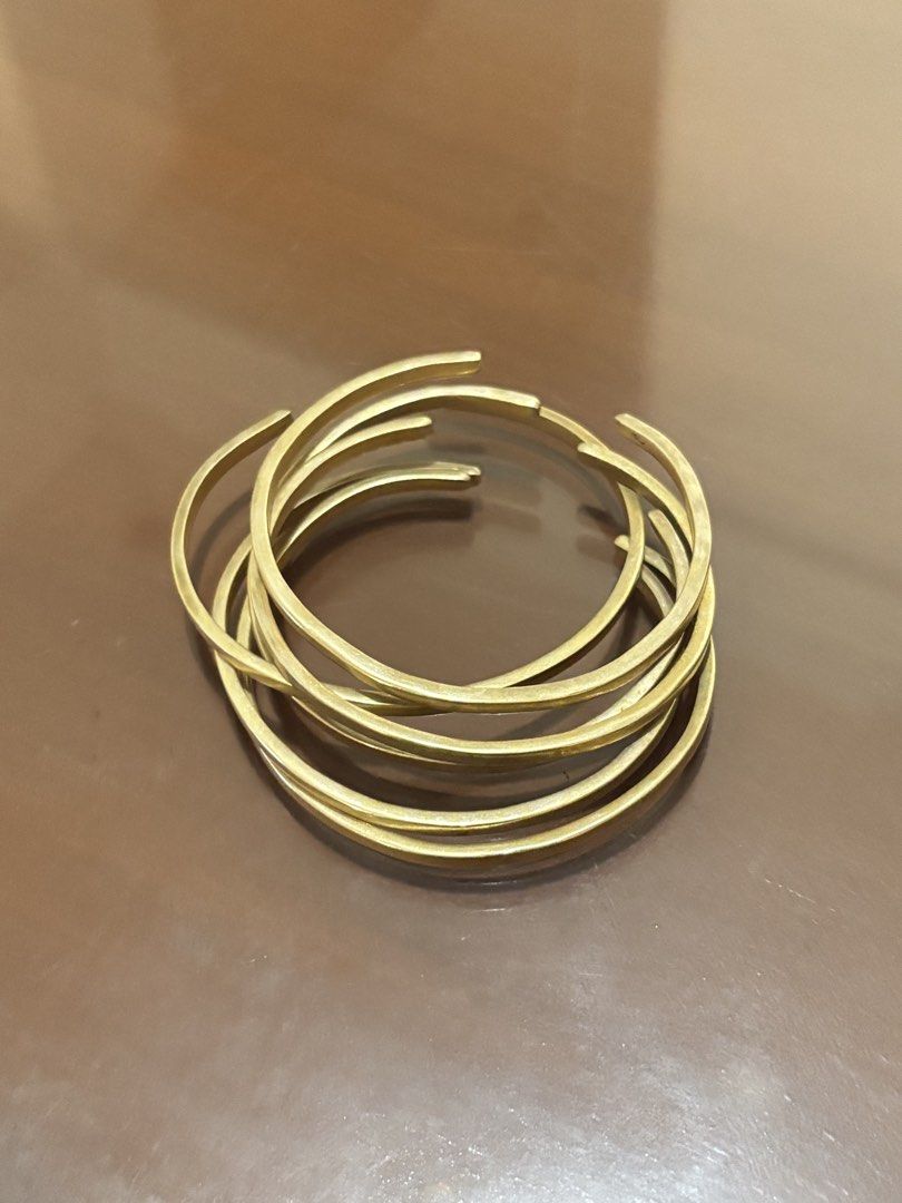 Thin Brass Stackable Bangle Set (Category: Bracelets) located in San Fernando. Submitted by nicoledweeby (Listing ID 1451702305, Image 1). Description: - Set of 6 gold tone bangles - Features a hammered texture - Stackable design, perfect for layering - Can be worn together or separately - Simple and chic style - Fits most wrists -SOLD AS SET.