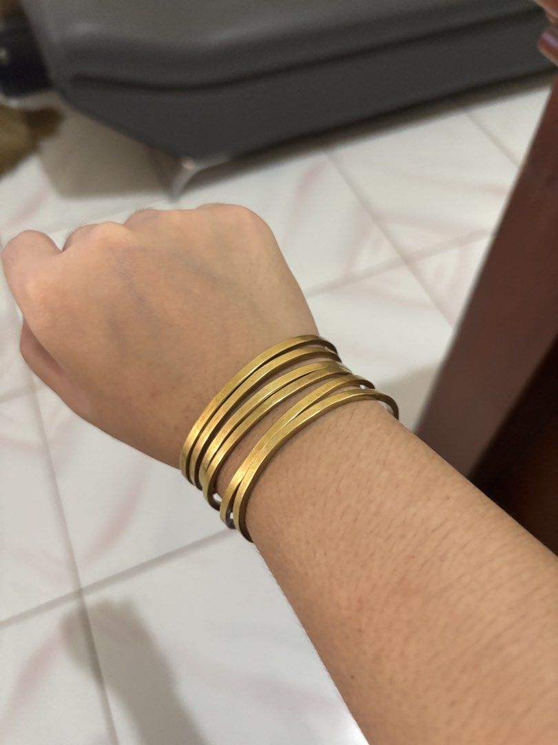 Thin Brass Stackable Bangle Set (Category: Bracelets) located in San Fernando. Submitted by nicoledweeby (Listing ID 1451702305, Image 2). Description: - Set of 6 gold tone bangles - Features a hammered texture - Stackable design, perfect for layering - Can be worn together or separately - Simple and chic style - Fits most wrists -SOLD AS SET.