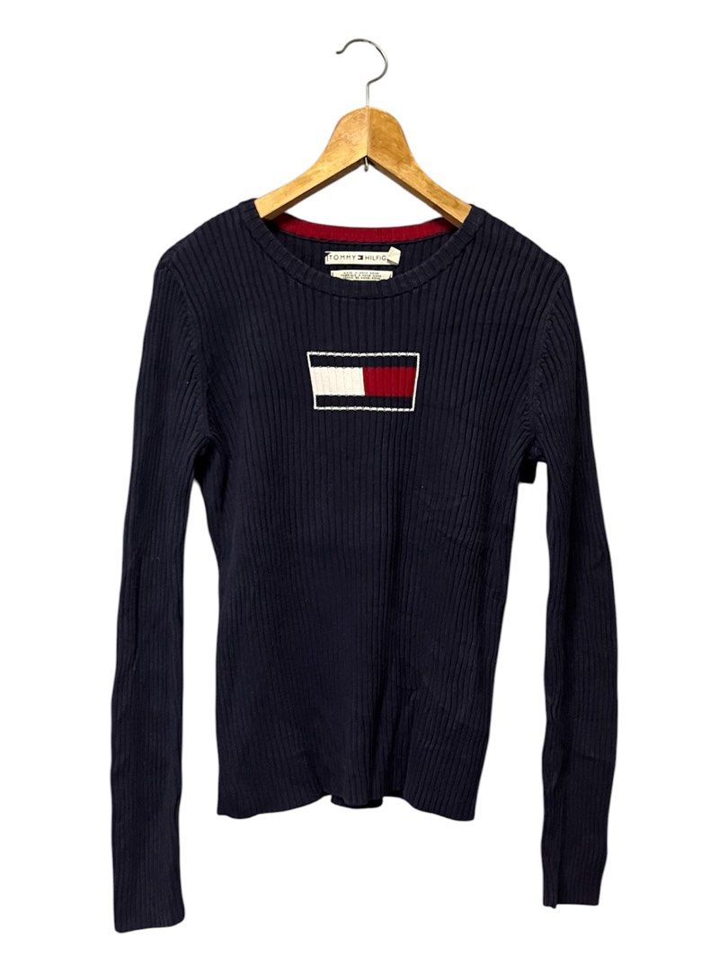 Tommy Hilfiger Navy Blue Ribbed Sweater Size M (Category: Longsleeves) located in Cabuyao City. Submitted by bulandos (Listing ID 1451852568, Image 1). Description: - Navy blue ribbed sweater - Brand: Tommy Hilfiger - Classic Tommy flag logo on chest - Material: 100% Cotton - Size: Medium (M) - Origin: Made in Hong Kong - Versatile for layering or standalone wear.