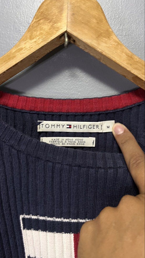 Tommy Hilfiger Navy Blue Ribbed Sweater Size M (Category: Longsleeves) located in Cabuyao City. Submitted by bulandos (Listing ID 1451852568, Image 2). Description: - Navy blue ribbed sweater - Brand: Tommy Hilfiger - Classic Tommy flag logo on chest - Material: 100% Cotton - Size: Medium (M) - Origin: Made in Hong Kong - Versatile for layering or standalone wear.