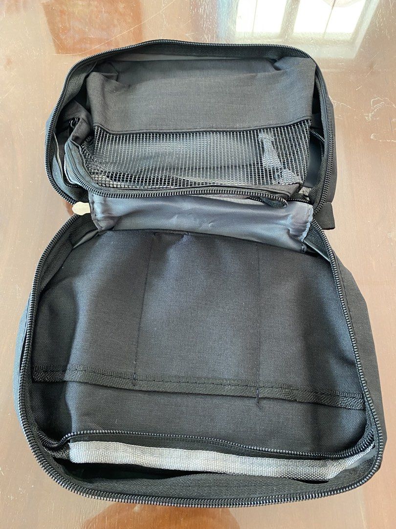 Travel Toiletry Bag with Hook - Black Polyester (Category: Purses & Pouches) located in Bacoor. Submitted by gracemc2024 (Listing ID 1451722594, Image 3). Description: - Durable black toiletry bag perfect for travel. - Made from sturdy 300D polyester material. - Multiple compartments for organized storage. - Includes a convenient mesh pocket. - Features a built-in hook for hanging. - Compact and easy to pack when folded..
