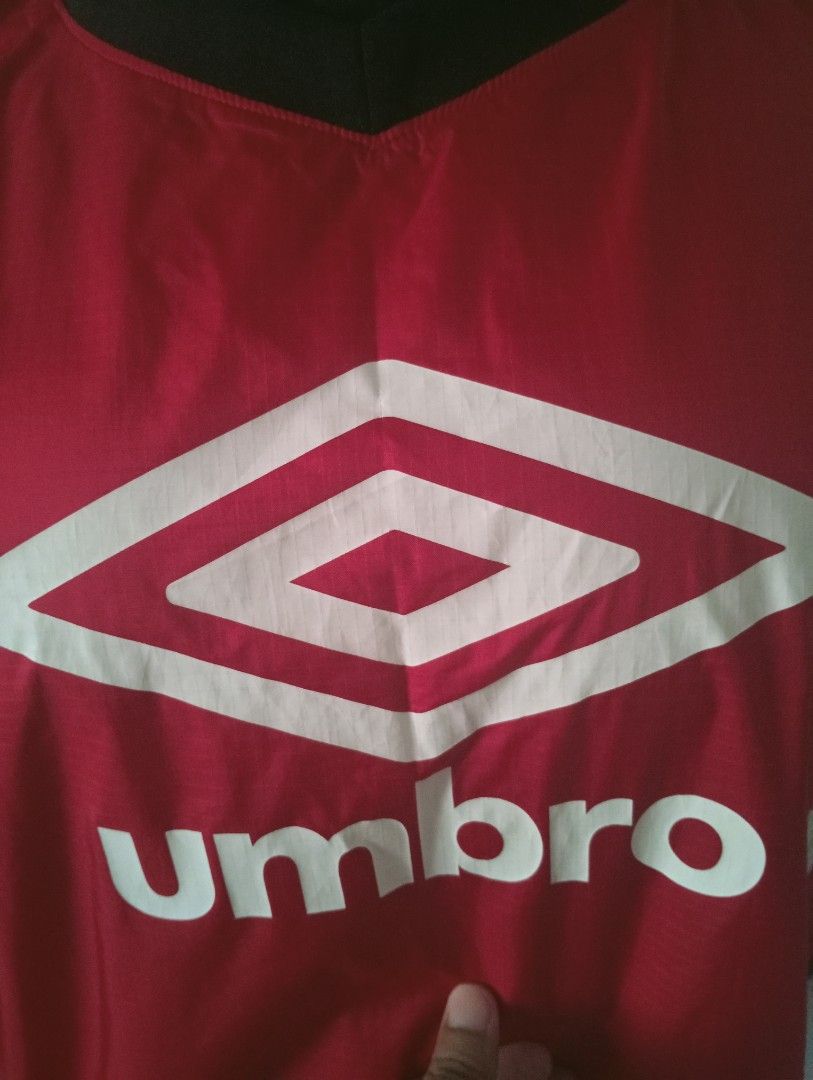 Umbro Red Jacket (Category: Coats, Jackets and Outerwear) located in Tanah Merah. Submitted by jaapickers_2449 (Listing ID 1451724924, Image 2). Description: - Classic red Umbro jacket - Stylish black collar and sleeve accents - Prominent Umbro logo on the front - Elasticated cuffs for a comfortable fit - Ideal for sports, training, or everyday casual wear - Pit 22 inch - Long 27 inch.