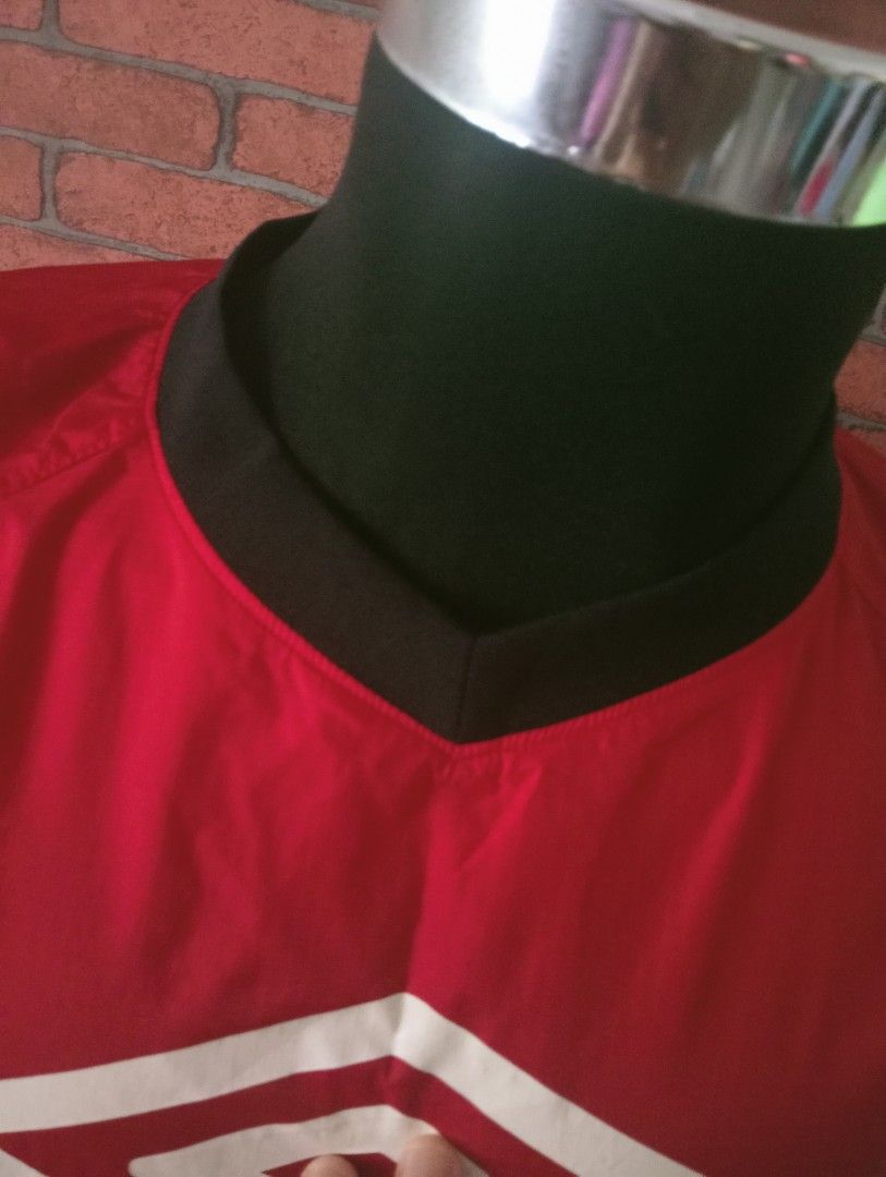 Umbro Red Jacket (Category: Coats, Jackets and Outerwear) located in Tanah Merah. Submitted by jaapickers_2449 (Listing ID 1451724924, Image 3). Description: - Classic red Umbro jacket - Stylish black collar and sleeve accents - Prominent Umbro logo on the front - Elasticated cuffs for a comfortable fit - Ideal for sports, training, or everyday casual wear - Pit 22 inch - Long 27 inch.