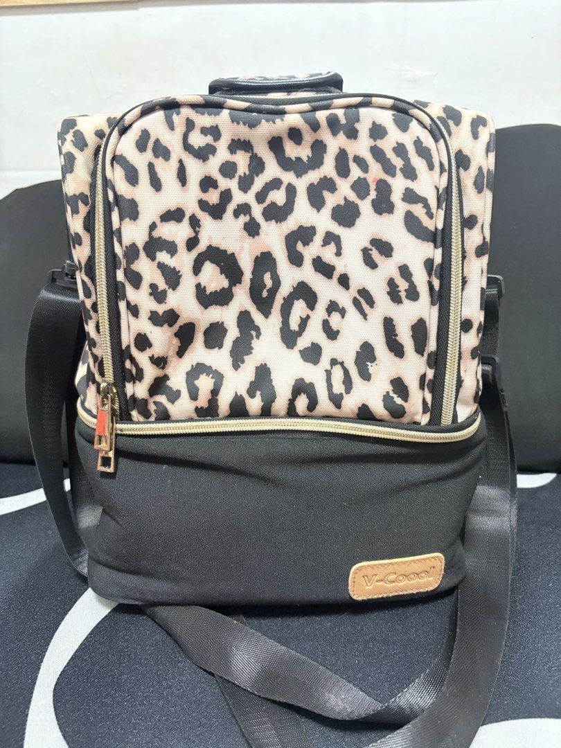 V-Cool Leopard Print Cooler Bag with Ice Packs (Category: Food Organization & Storage) located in Marikina City. Submitted by loca. (Listing ID 1451770353, Image 1). Description: - V-Cool leopard print cooler bag - Includes two V-Cool ice packs - Main compartment for storage - Front zip pocket for essentials - Adjustable shoulder strap for easy carrying - Ideal for keeping food and drinks cool during travel or outings.