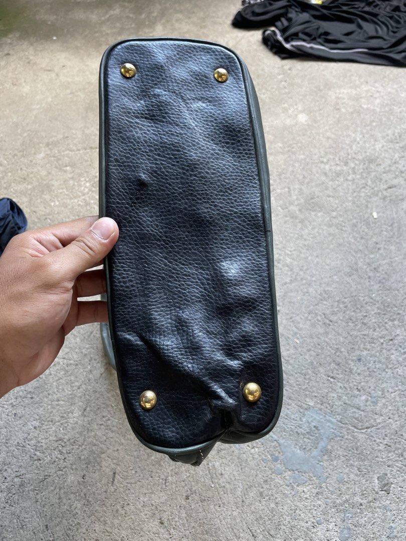 Vintage Black & Green Leather Dome Handbag (Category: Luxury Bags & Wallets) located in Siniloan. Submitted by rethr1ft (Listing ID 1451752876, Image 3). Description: - Classic dome handbag style - Black pebbled leather with elegant green accents - Polished gold-tone hardware and signature emblem - Secure top zipper closure - Convenient back pocket - Interior zippered compartment for organization - Four metal feet to protect the base - Ideal for 