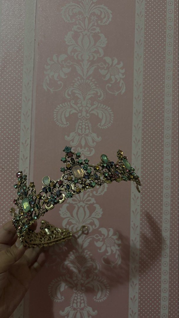 Vintage Style Rhinestone Crown Tiara (Category: Hair Accessories) located in Manila. Submitted by aewinterlemon (Listing ID 1451798115, Image 2). Description: - Beautiful vintage-style crown - Looks brand new - Bought in USA - Gold-toned metal with colorful rhinestones and faux gems - Ideal for costumes, parties, or decorative display - Features a secure clasp closure - Approximate measurements: 6 inches wide, 3 inches tall - Unique and eye-catch